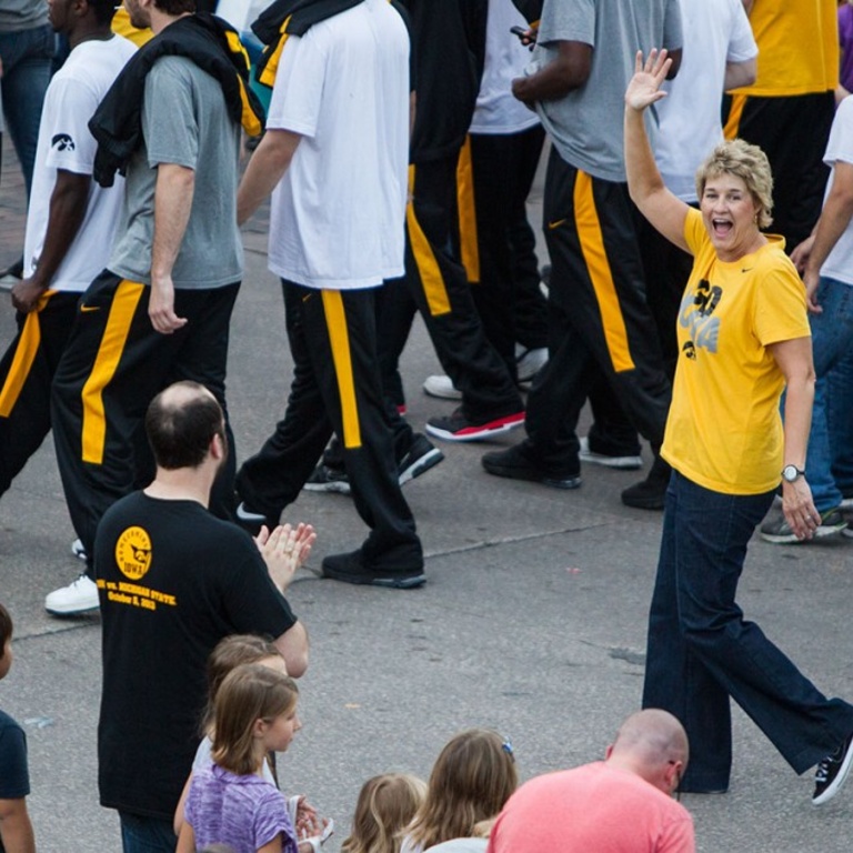 A woman waving in a parade