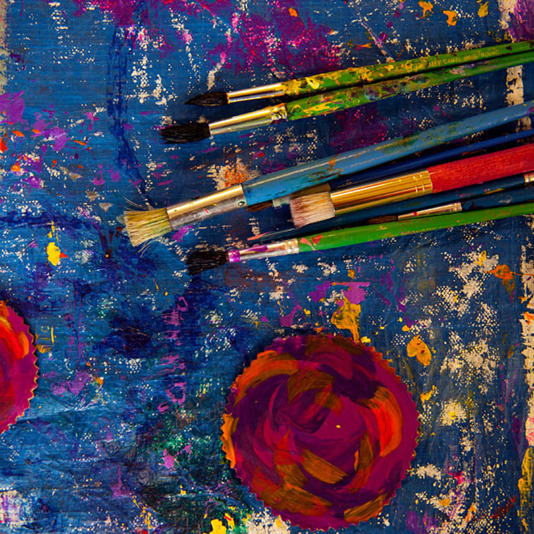 Paint brushes on a colorful palette.