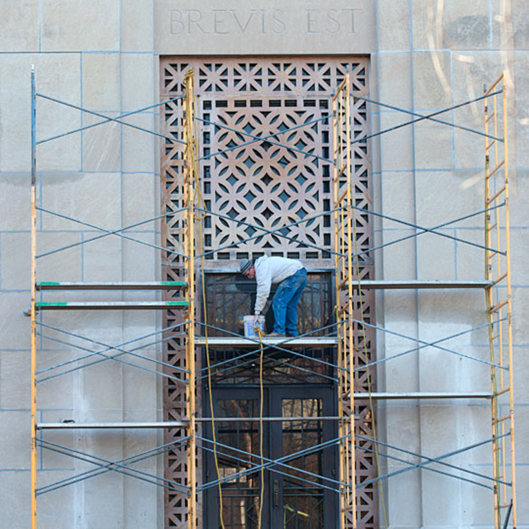 Work on the face of the old art building.