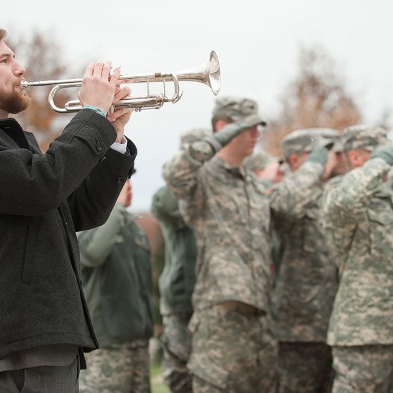 Reveille is played while the flag is raised