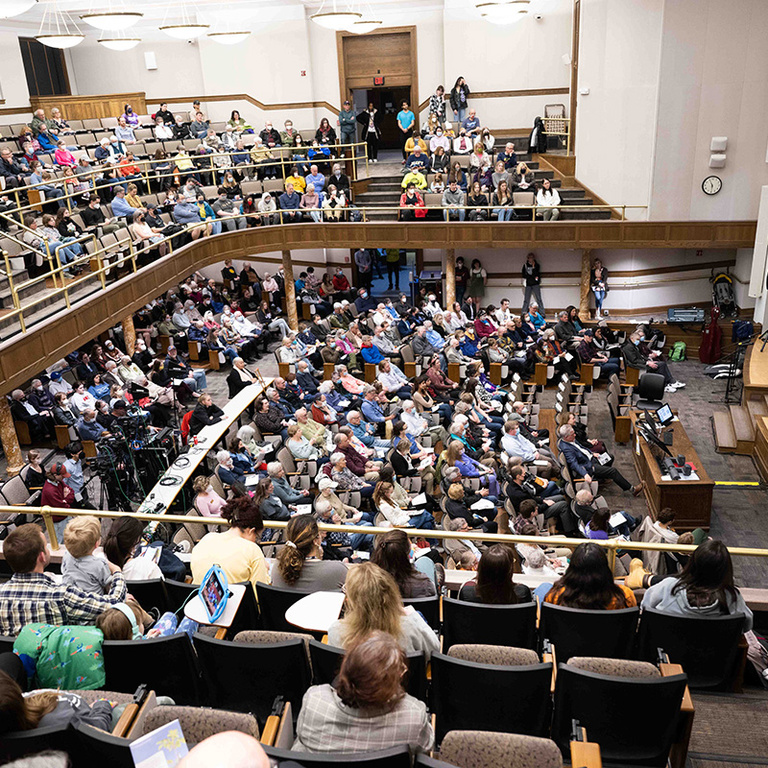 Attendees filled Macbride Hall Auditorium to hear speeches ahead of the tree planting. The event was moved indoors due to rain.