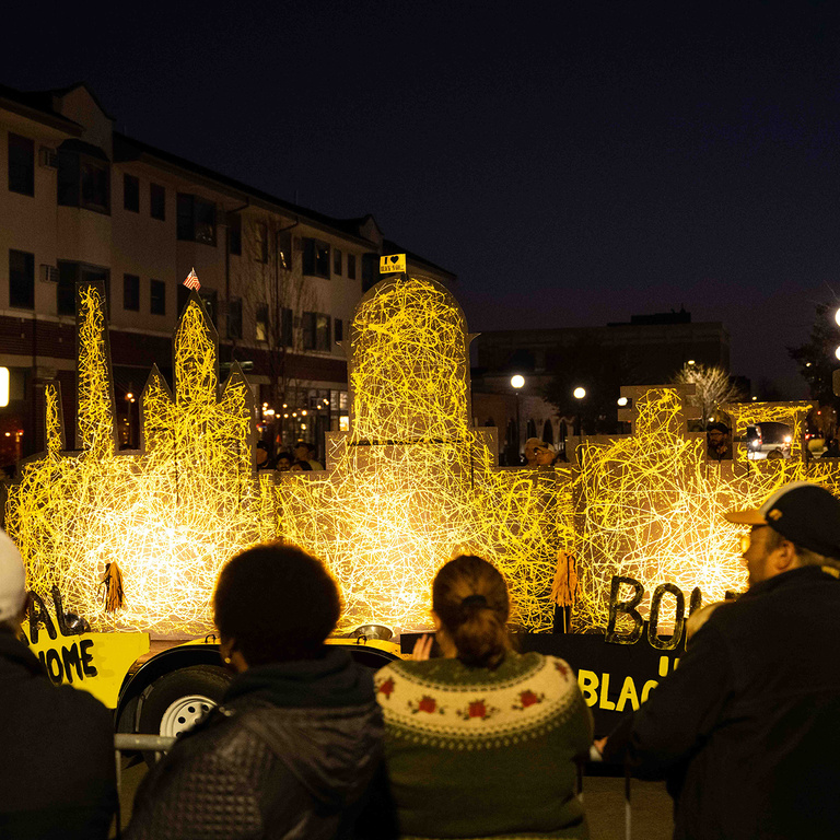 A Jackson Pollock-inspired painting of the Pentacrest makes its way through Iowa City during the homecoming parade.