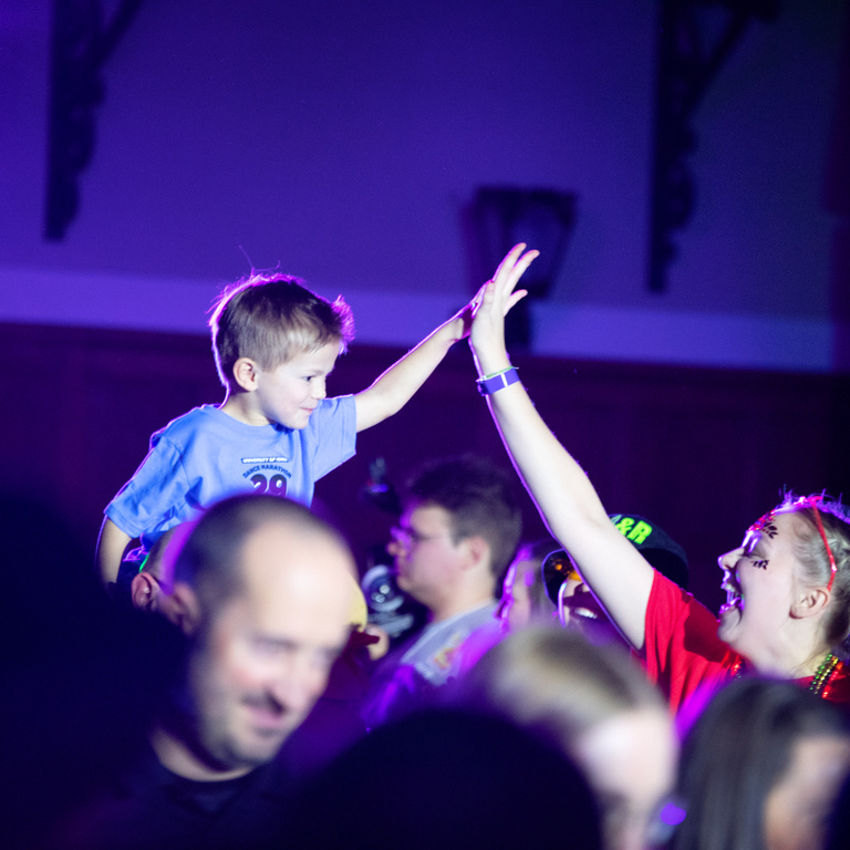 Families make their entrances to the IMU for DM29 and kiddos give high fives.