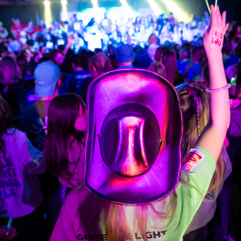 A woman in a cowboy hat dances along during Dance Marathon 29.