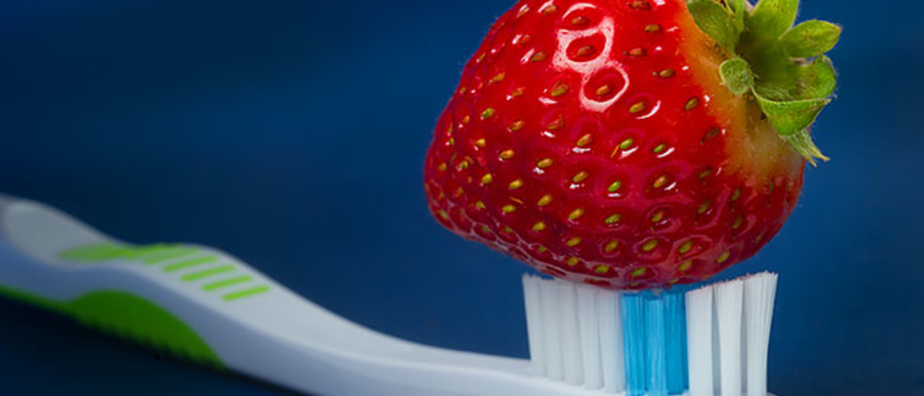 A strawberry on a toothbrush