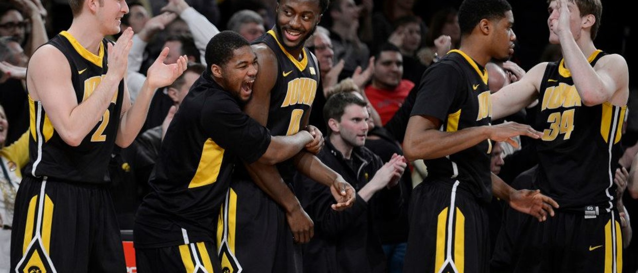 Men's basketball players celebrate a victory over Maryland