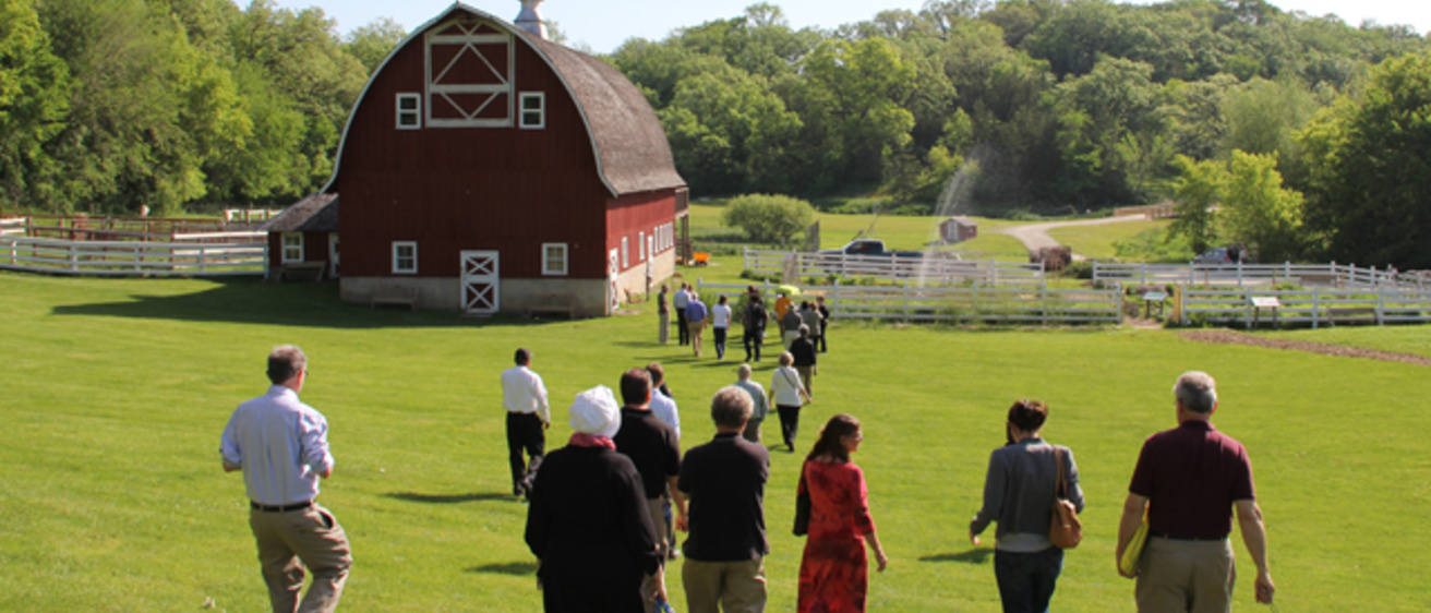 UI faculty walking toward a barn