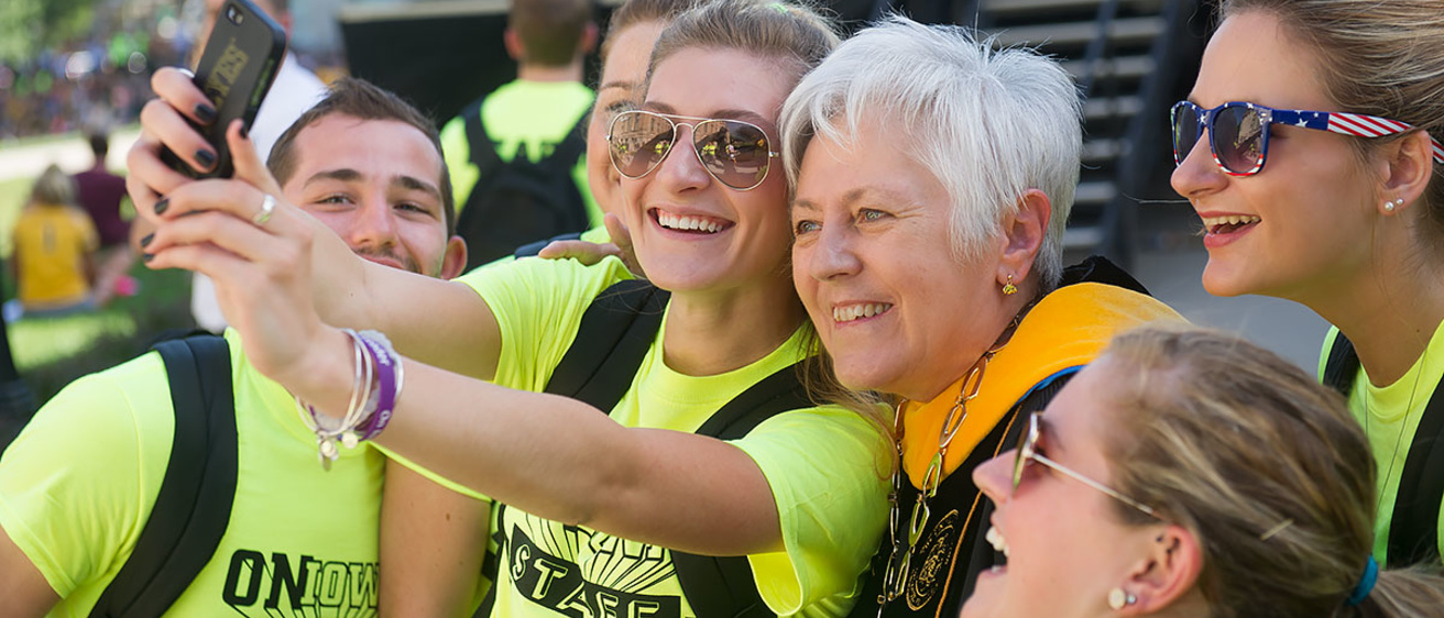 Sally Mason takes a selfie with students