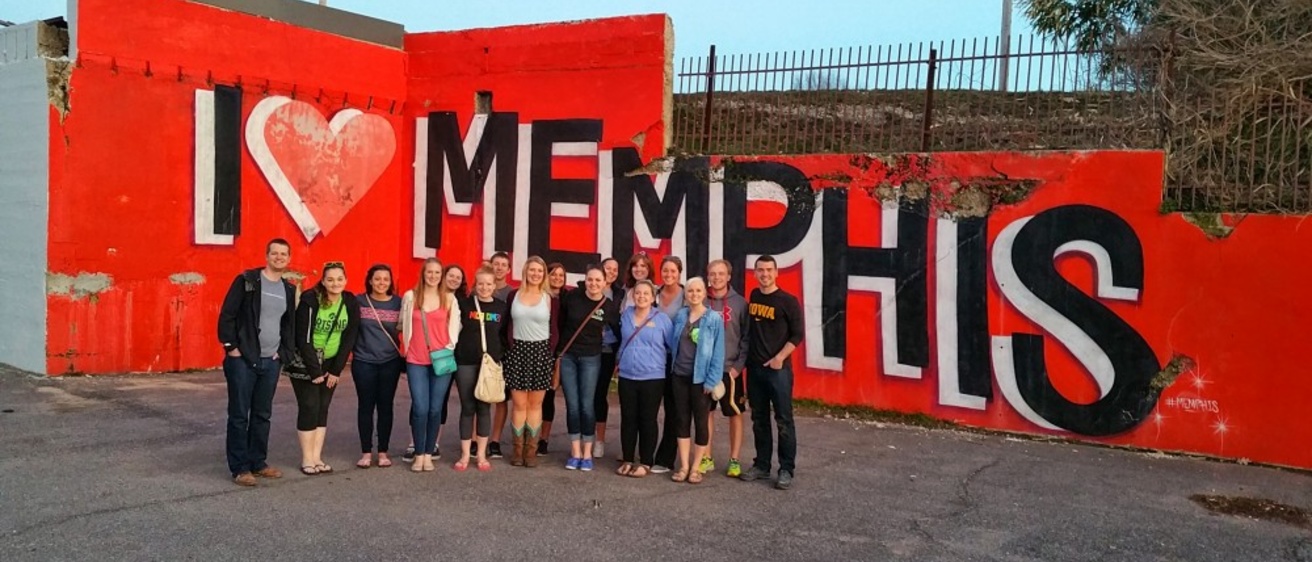 A group of students stand in front of an "I Love Memphis" sign.