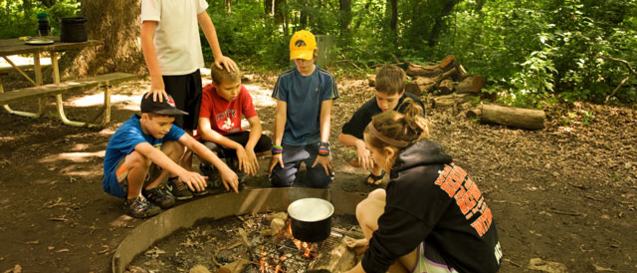 kids sitting around a campfire