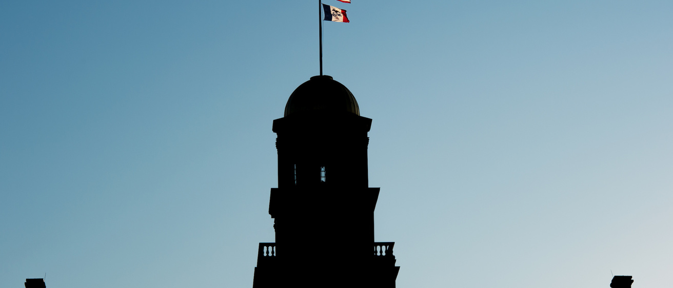 old capitol silhouette with flags visible