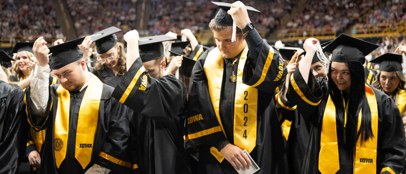 Graduates moves their tassels at spring 2024 CLAS commencement ceremony