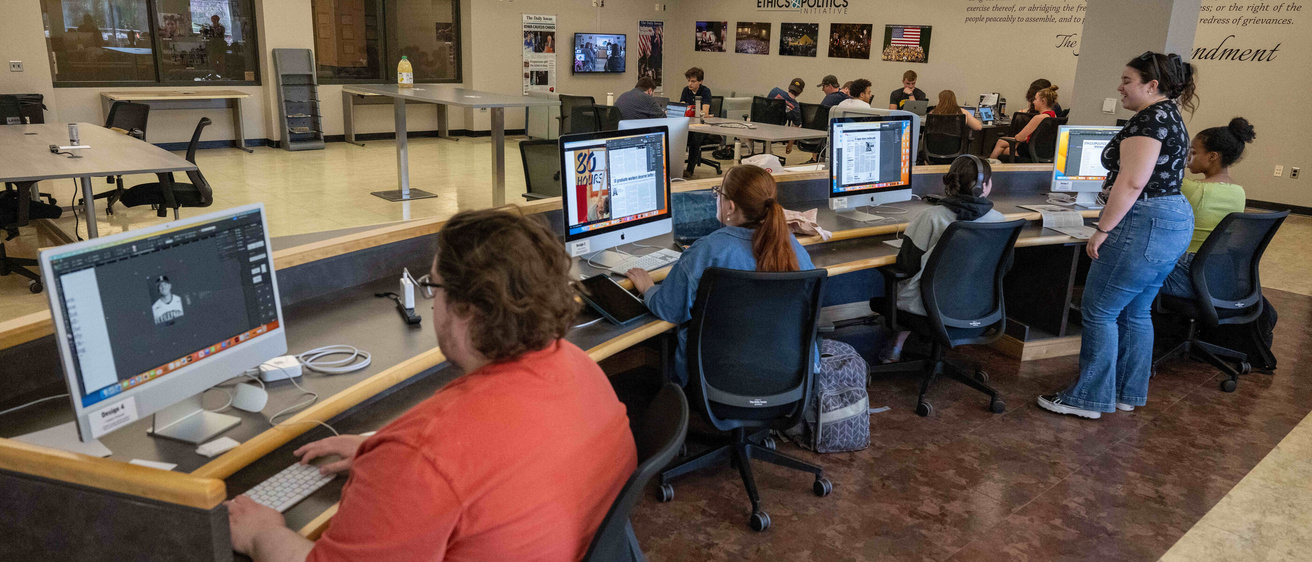 Students working on the Daily Iowan in the newsroom