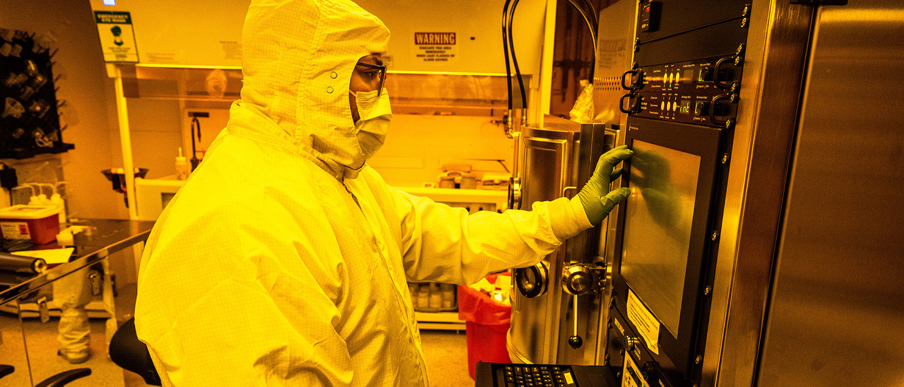a research professional wearing protective gear works in the Materials Analysis, Testing, and Fabrication (MATFab) Facility