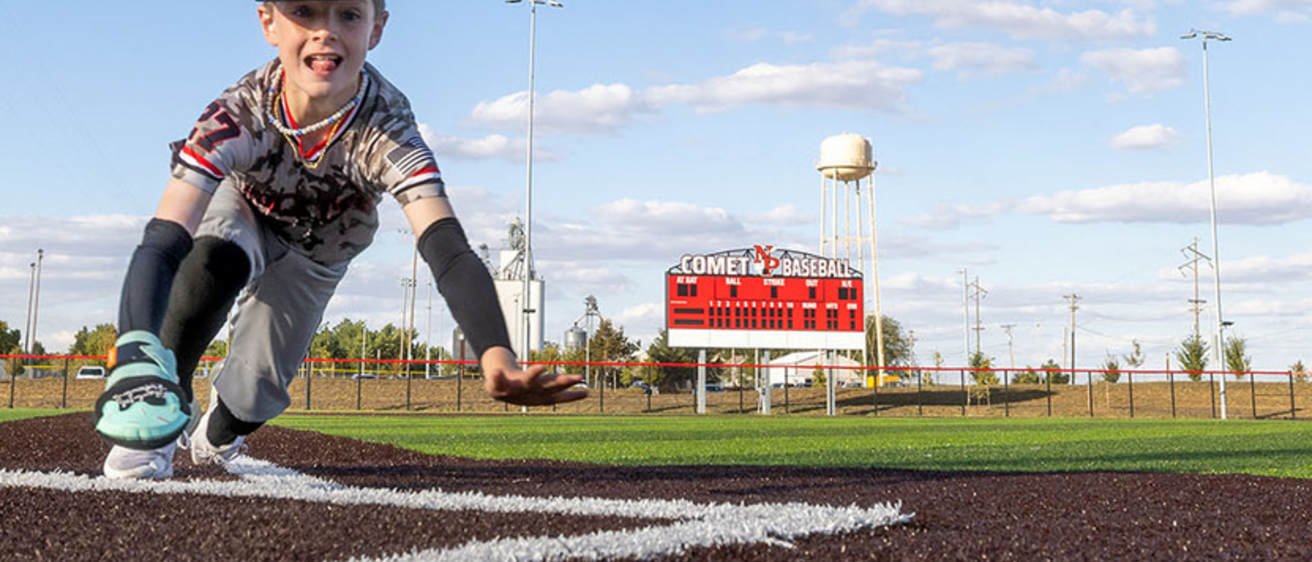 A child in a baseball uniform who was a patient in the burn center