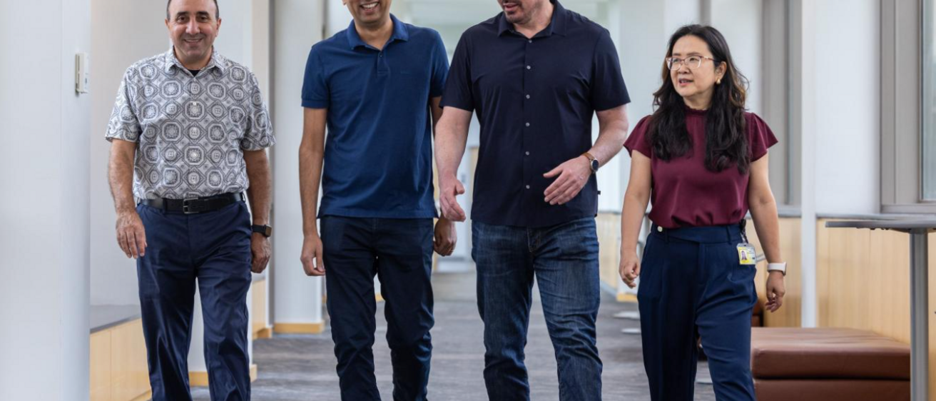 Four researchers walk in a hallway at the UI Fraternal Order of Eagles Diabetes Research Center. From left to right: Kamal Rahmouni, Bhagirath Chaurasia, Eric Taylor, and Ling Yang.