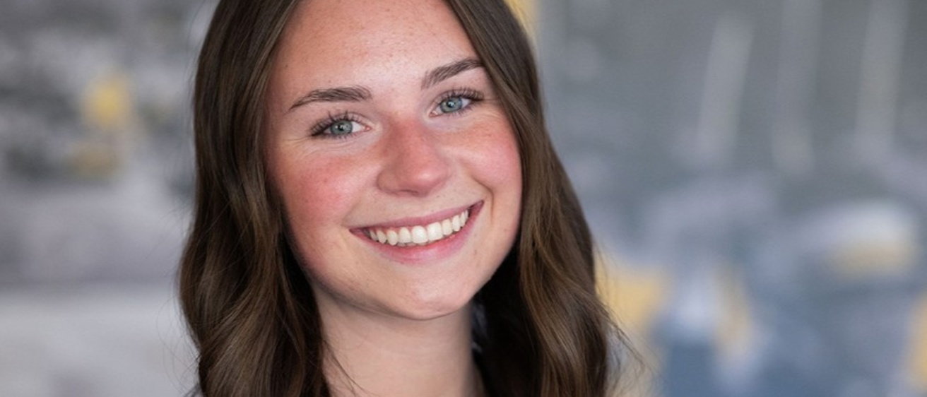 A close up of Amanda Earley - a female student with long dark hair and a big smile.