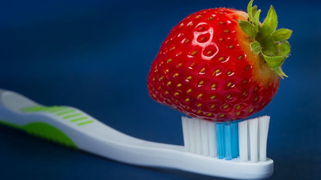 A strawberry on a toothbrush
