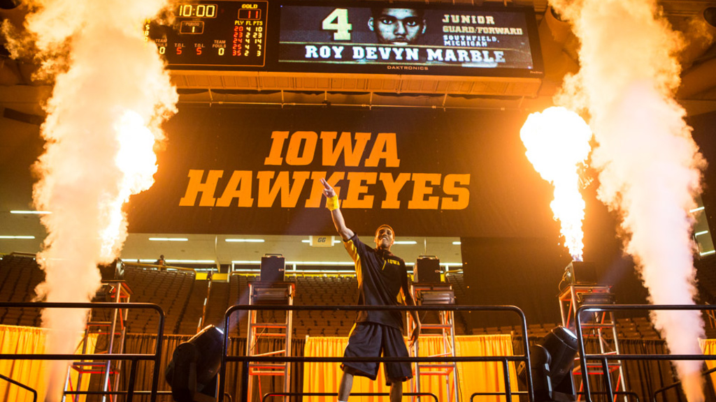 Iowa basketball player surrounded by fireworks.