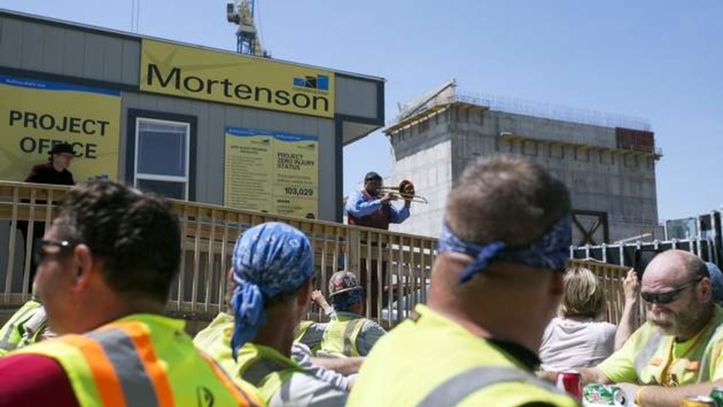 Wycliffe Gordon plays trombone as construction workers eat lunch at the Hancher Auditorium site on the University of Iowa campus in Iowa City on Wednesday, May 21, 2014. 