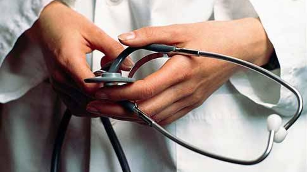 A doctor hold's a stethoscope in their hands.