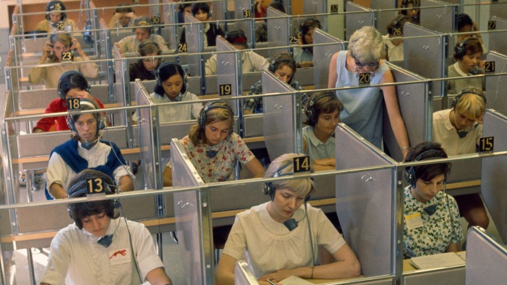 women wearing headphones in language laboratory