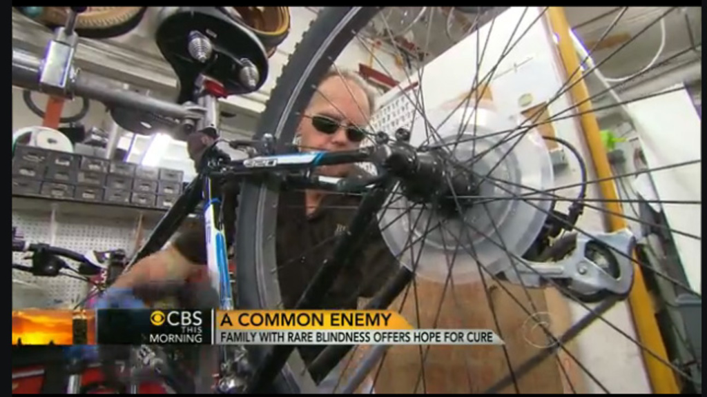 A photo of Jerry Jackson, a blind man, who is a bicycle mechanic, working on one of his bikes