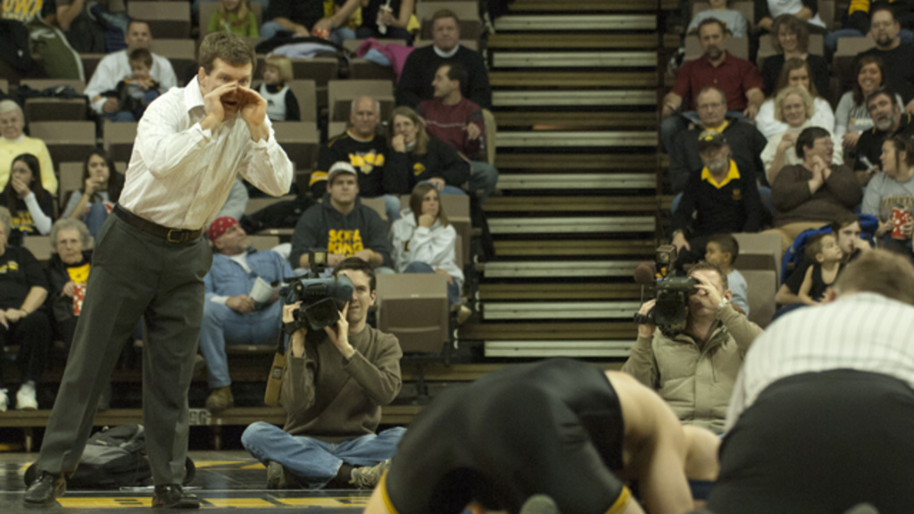 tom brands coaches at matside during a 2008 wrestling match