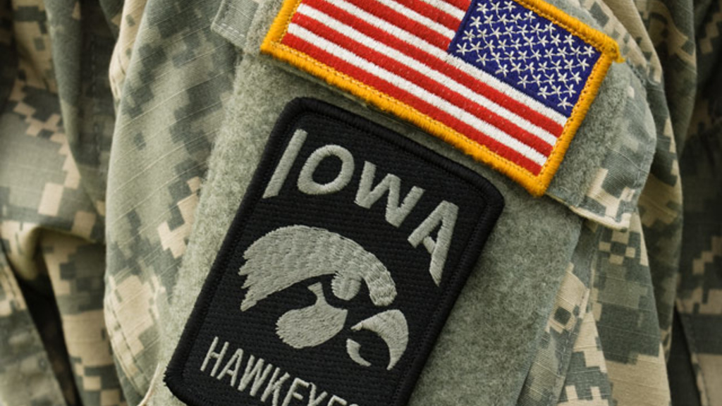a u.s. flag patch and a tigerhawk patch on the arm of an ROTC member