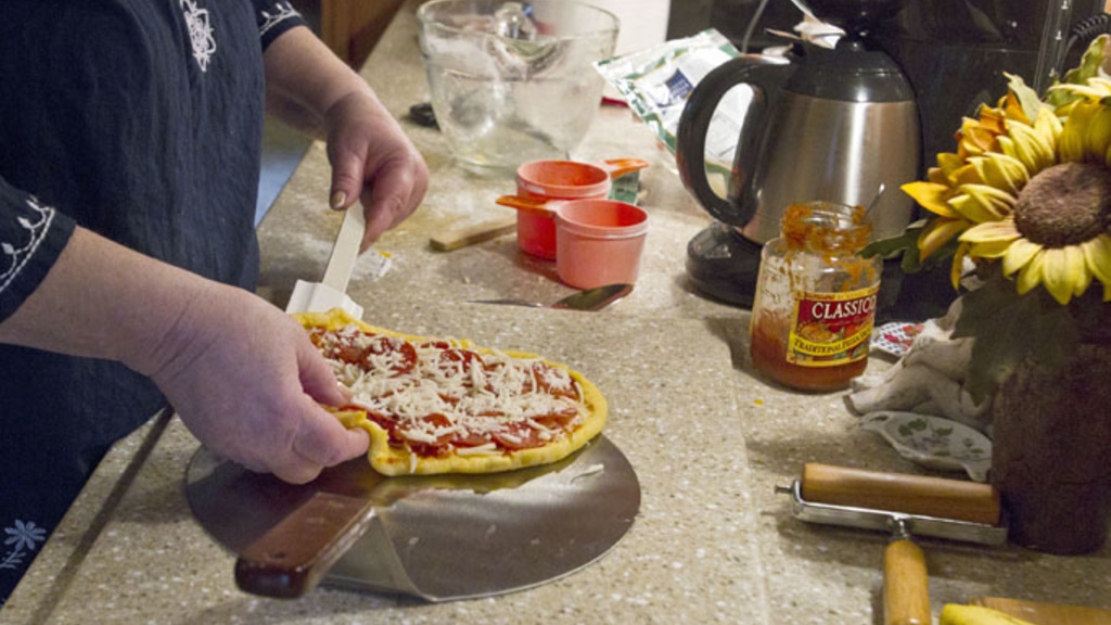 Theresa Brandon prepares a gluten-free pizza in her home in southwest Cedar Rapids on Monday, June 24, 2013.  Photo by Kaitlyn Bernauer/The Gazette