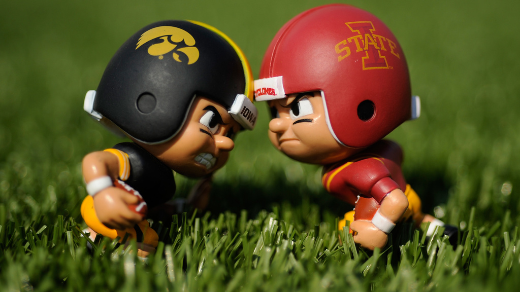 figurines wearing iowa and iowa state uniforms face off