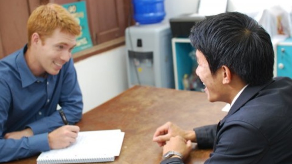UI doctoral student in linguistics, Douglas Cole, interviews a resident of Laos for his research while abroad on the Lao language.
