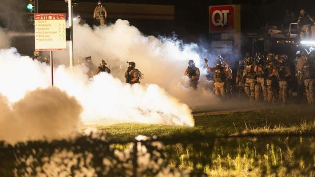 Riot police clear a street with smoke bombs while clashing with demonstrators in Ferguson, Missouri August 13, 2014. (REUTERS/Mario Anzuoni) Read more at http://thegazette.com/subject/news/iowa-professor-sheds-light-on-racial-tension-in-ferguson-20140821#