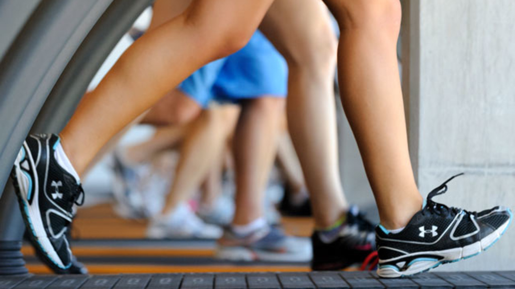 Close-up color image of legs on treadmill.
