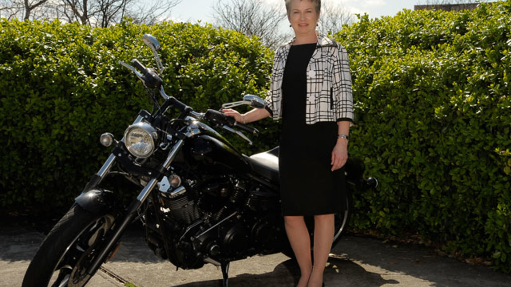 Sarah Gardial stands beside her motorcycle