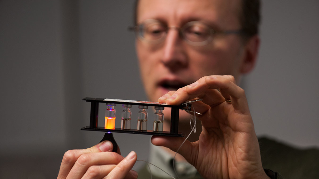 John Prineas, UI associate professor of physics and astronomy, demonstrates a fan powered by light from a flashlight illuminating a semiconductor solar cell 