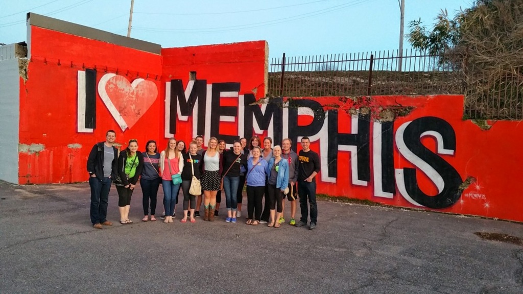 A group of students stand in front of an "I Love Memphis" sign.