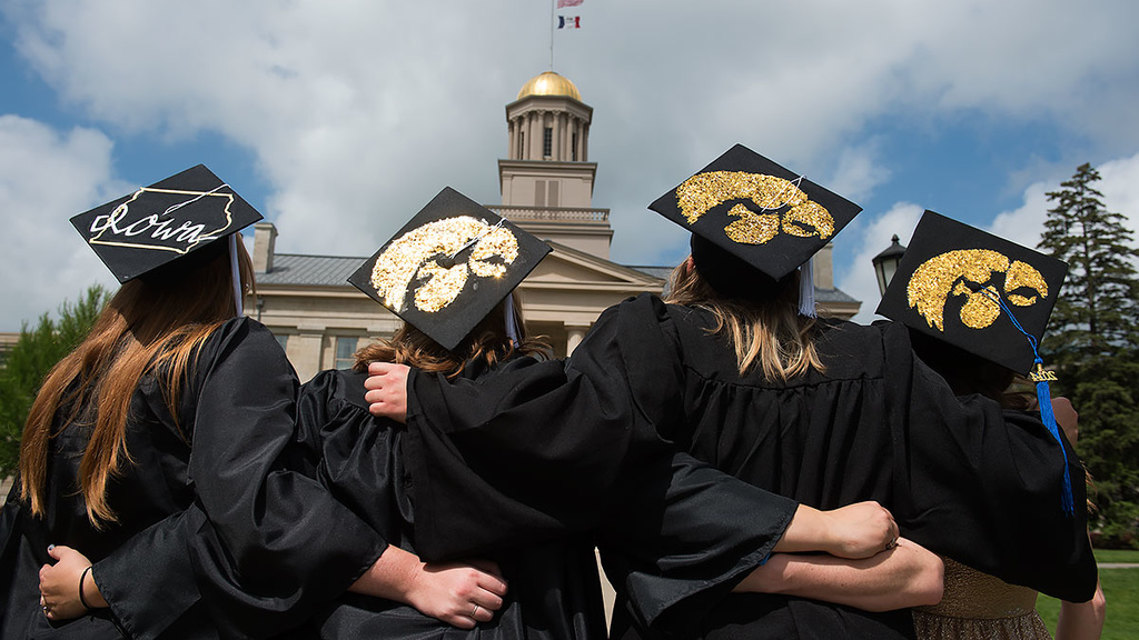 Graduates take photo in front of the Old Capitol.