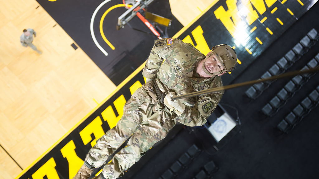 Maj. Chris Guderski rappels about 66 feet from the rafters to the court in Carver-Hawkeye Arena.