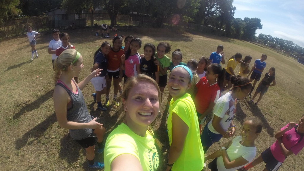 Soccer players take a selfie with kids.