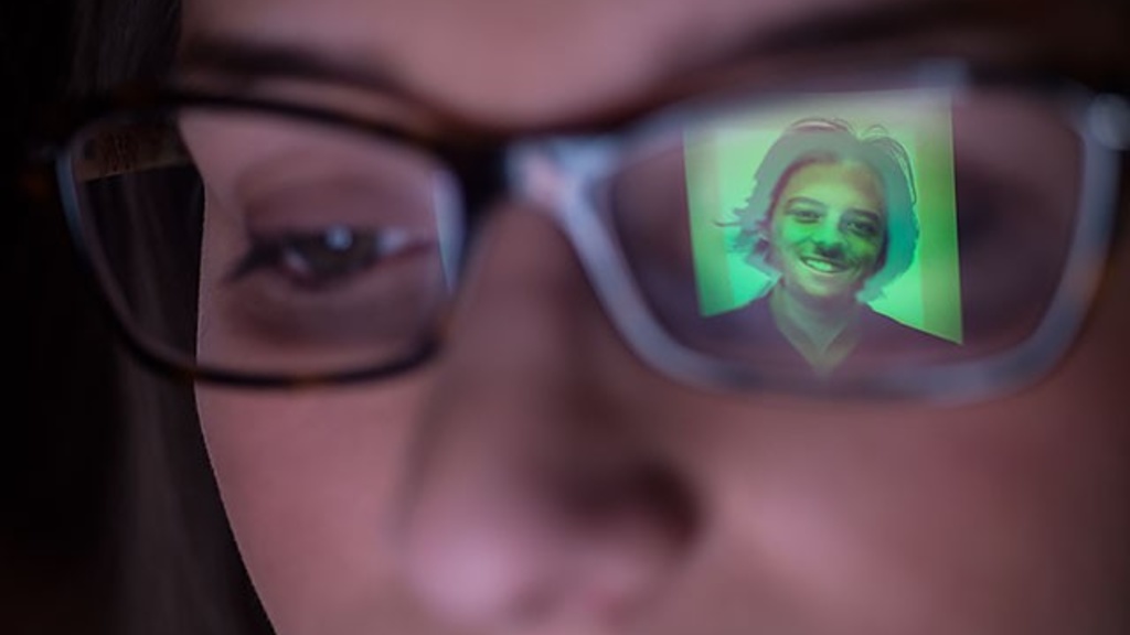 A dating profile picture reflected in a viewer's glasses