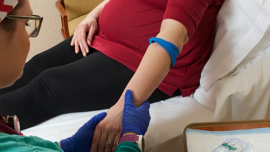 Nurse drawing blood from a pregnant woman