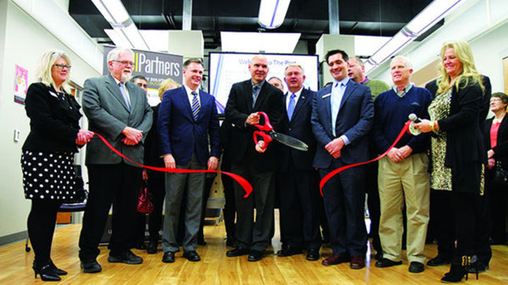 Dignitaries gather for a UI ribbon cutting.