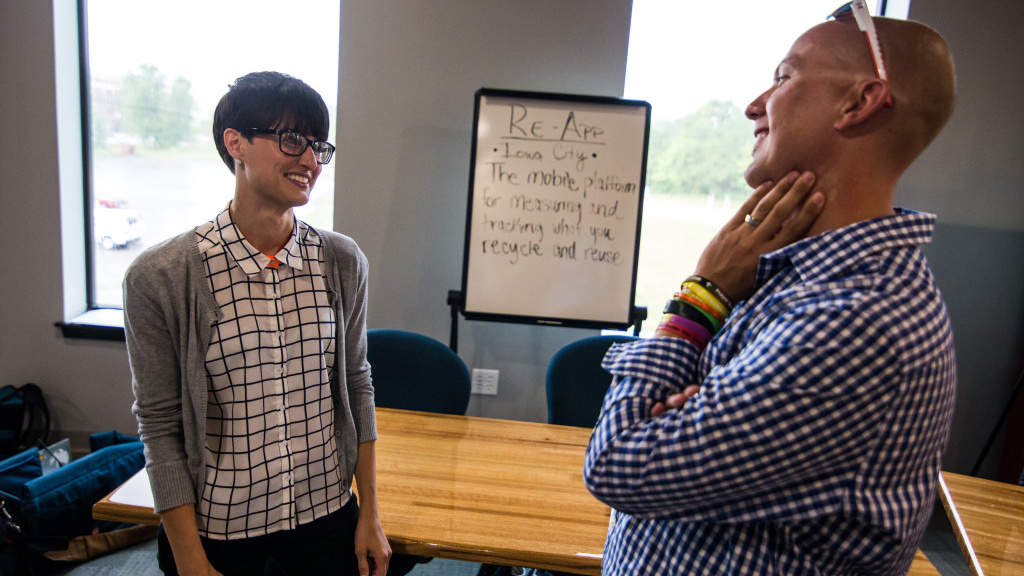 University of Iowa grad Blake Rupe talks with a colleague.