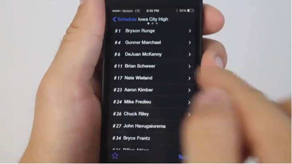 A person uses a hand held mobile device to search for a sports score