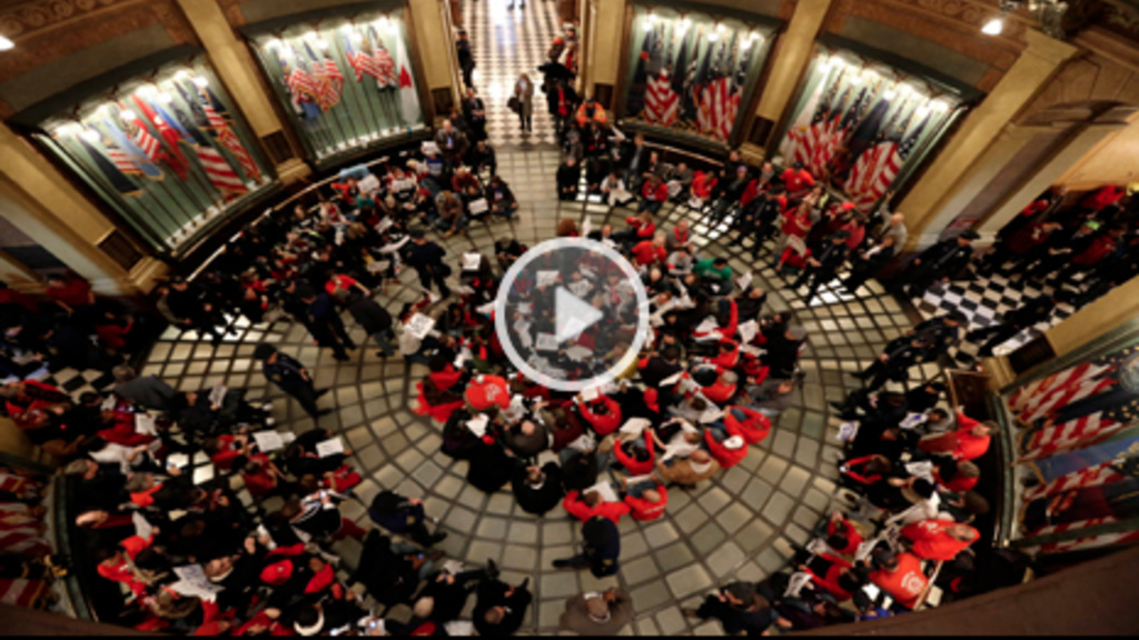 Protesters sit in the rotunda of the State Capitol in Lansing, Mich., Tuesday, Dec. 11, 2012. The crowd is protesting right-to-work legislation passed last week. Michigan could become the 24th state with a right-to-work law next week. Rules required a fiv