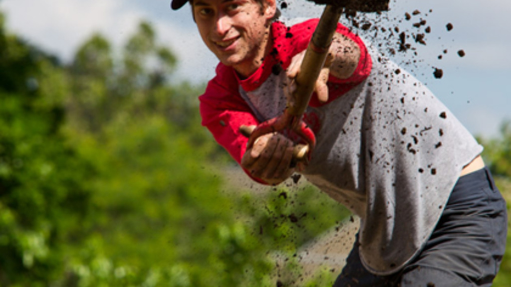 Rob Koehler digs along outer edge of herb garden
