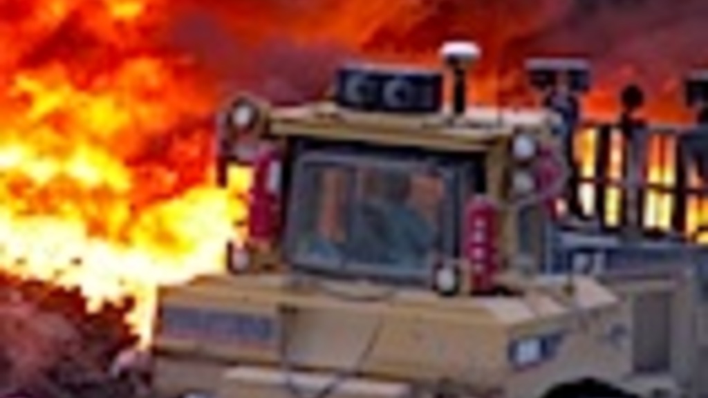 Using heavy machinery to fight a raging blaze. By Rick Fosse, City of Iowa City.