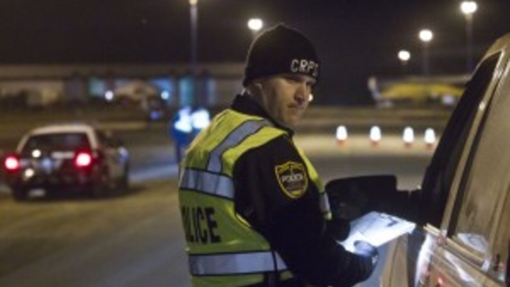 Officer Shawn Burke administers a traffic safety check point organized by Cedar Rapids Police in Southwest Cedar Rapids which started at 11:00p.m. on March 29, 2013. (Kaitlyn Bernauer/The Gazette)