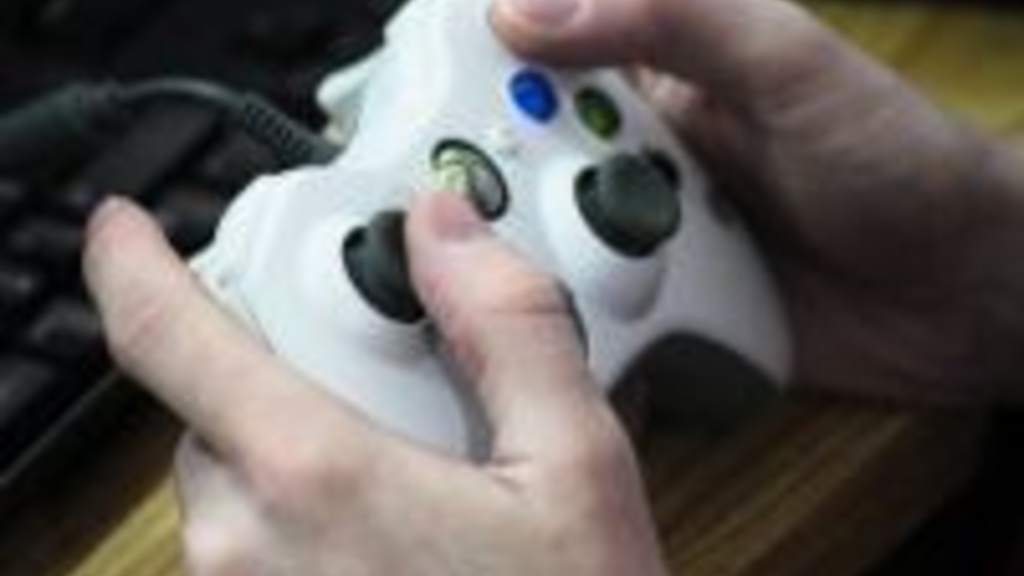 A closeup photo of someone&#039;s hands on a video game
